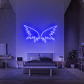 Donkerblauw verlichte Angel Wings 2 boven een bank in een moderne woonkamer